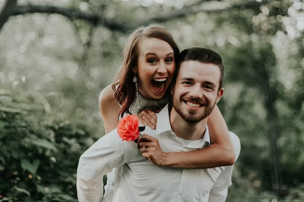 A couple expresses love and affection while posing for a photo.